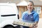 Female Caterer Delivering Tray Of Sandwiches To House