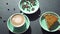 Female Caucasian hand taking plate with sweet pie from table with coffee and beans. Top view of food and drink in coffee