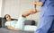 Female Caucasian physiotherapist rehabilitation with Hispanic patient. The doctor doing stretching on patient\'s pain body