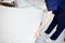 A female chambermaid making bed in hotel room