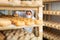 Female cheesemaker in protective mask checks the quality of the cheese.