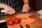 Female chef is cutting salmon