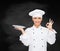 Female chef with empty plate showing ok sign