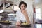 Female chef examining appetizer plate at order station