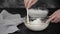 Female chef making whipped cream for cake.