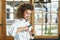 Female chef opening a bottle of beer at the kitchen