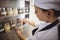 Female chef selecting a spice jar in the commercial kitchen