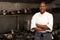 Female Chef Standing Next To Cooker