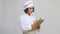 Female chef in toque with pen writing to clipboard