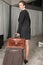 Female chef travelling with suitcase and brief case looking over