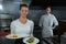 Female chefs holding food plates