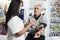 Female Chemist Checking Blood Pressure Of Senior Man