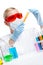 Female chemist holds a vial with orange liquid