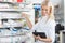 Female Chemist Standing in Pharmacy Drugstore