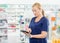 Female Chemist Using Digital Tablet In Pharmacy