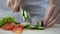 Female chief cook chopping vegetables, cooking delicious fresh salad for lunch