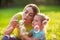 Female child blows soup foam and make bubbles with her mother in