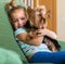 Female child playing with Yorkie