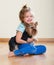 Female child playing with Yorkie