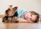 Female child playing with Yorkie