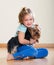 Female child playing with Yorkie