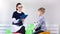 Female child psychologist making support discussing with little boy at therapy session