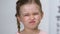 Female child squinting eyes closeup, blurry vision, reading difficulties, strain