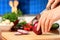 Female chopping food ingredients.