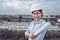 Female Civil Engineer in Safety Hard Hat With Blueprint Paper While Control Production in Manufacturing Factory. Portrait of