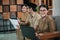 female civil servant smile using laptops and male civil servants holding documents while sitting