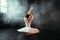 Female classical ballet performer sitting on floor