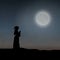 A Female Clergy Praying Under The Moonlight