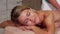 Female client enjoying relaing body massage at spa salon