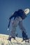 Female climber ascending a snowy slope.