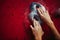 Female climber hands holding artificial boulder in climbing gym, closeup shot