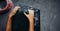 Female climber hands holding artificial boulder in climbing gym, closeup shot