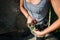 Female climber in safety harness tying rope in eight knot