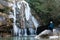 Female climber watching the frozen winter waterfall