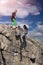 . Female climbers helping each other on rock wall