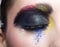 Female closed eye with unusual artistic painting makeup