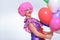 Female Clown with Balloons Smiling at the Camera