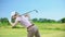 Female with club playing golf, suffering pain in back, sports trauma and health