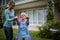 Female coach assisting senior woman in performing exercise