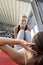 Female Coach Assisting Woman In Doing Sit-Ups