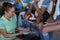 Female coach discussing over clipboard with volleyball players