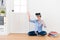 Female college student sitting on wooden floor