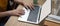 Female college student working on her assignment with mock-up  laptop on wooden worktable