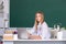 Female college student working on a laptop in classroom, preparing for an exam. Teenager student girl.