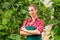 Female commercial gardener in green house