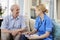 Female Community Nurse Visits Senior Man At Home